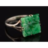 A pierced jade square panel mounted ring: the shank stamped '9ct', ring size N.