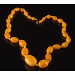 A graduated amber bead single string necklace: with 29 oval beads,