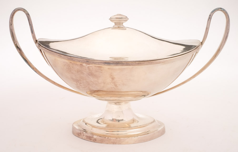 A Sheffield Plate boat-shaped sauce tureen and cover: with urn-shaped finial to the lift-off lid,