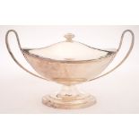 A Sheffield Plate boat-shaped sauce tureen and cover: with urn-shaped finial to the lift-off lid,