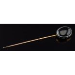 An oval banded agate single stone stick pin: the oval agate 20mm long x 15mm wide with closed back