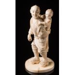 A Japanese carved ivory figure of a man with child on his back: Meilji period (1864-1912),