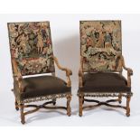 A pair of carved walnut and beech open armchairs in the 17th Century taste:,