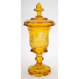 A Bohemian amber flashed goblet and cover: of octagonally faceted form with knopped stem and petal