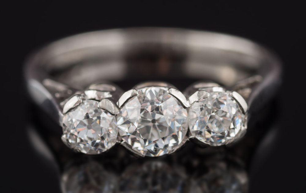 A diamond three stone ring: with graduated, old-cut diamonds approximately 0.30ct, 0.65ct and 0.