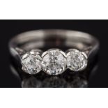 A diamond three stone ring: with graduated, old-cut diamonds approximately 0.30ct, 0.65ct and 0.