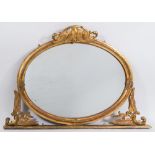 A Victorian carved giltwood and gesso oval overmantel mirror:,