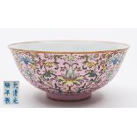 A Chinese porcelain bowl: the exterior decorated in the famille rose palette with lotus and peony