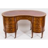 An Edwardian mahogany and inlaid kneehole desk:, of kidney-shaped outline, banded in satinwood,