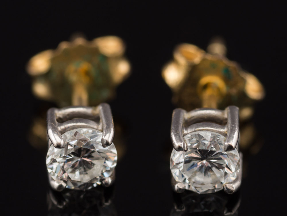 A pair of diamond single stone ear studs: each with a circular brilliant-cut stone approximately 0.