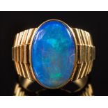 A gentleman's oval opal single stone ring: the opal approximately 18mm long x 12mm wide,