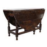An 18th Century oak oval gateleg table:, with a hinged top,