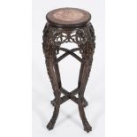 A Chinese carved wood circular jardiniere stand:, the top with a beaded edge,