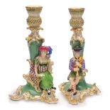 A pair of English porcelain figural candlesticks, probably Minton: modelled with Scottish musicians,