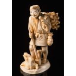A Japanese carved ivory okimono of a woodsman: Meiji period (1864-1912),