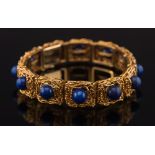 A French gold and lapis lazuli rectangular-link bracelet: of textured design,