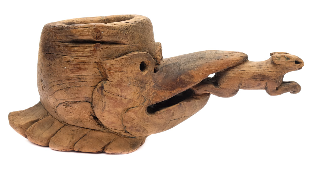 A native North American carved wooden cup: in the form of an eagle's head holding a rabbit in it's