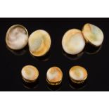 A pair of 18ct gold and operculum mounted cuff-links: (one shell replaced) and three matching studs
