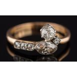 An 18ct gold and diamond six stone ring: with marquise-cut and cushion-shaped diamonds estimated to