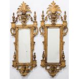 A pair of 19th Century Continental carved giltwood mirrors:, of small size,