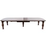A Victorian mahogany extending dining table:, the top with a moulded edge and curved leaves,