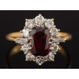 An 18ct gold, ruby and diamond oval cluster ring: with central oblong ruby 8.