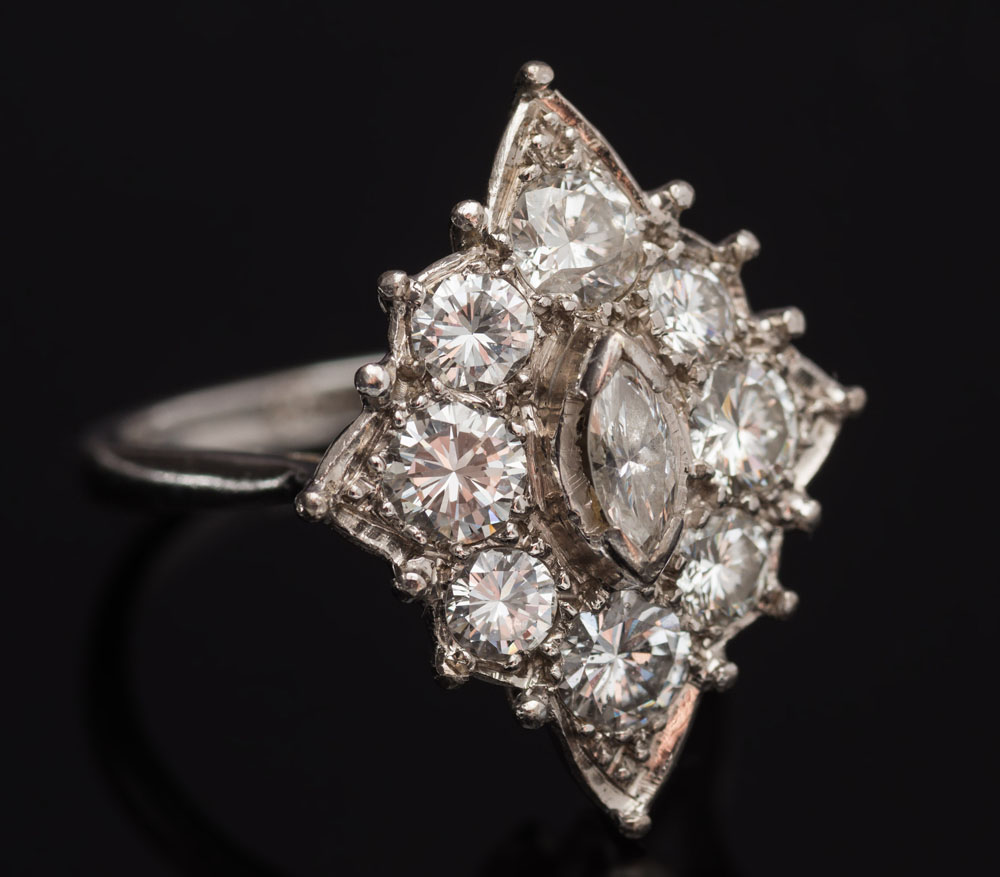 A diamond mounted marquise-shaped cluster ring: with central marquise-shaped diamond approximately