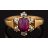 A late 19th century gold, ruby and diamond oval cluster ring: the oval ruby 5.5mm long x 4.