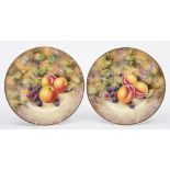 A pair of Royal Worcester porcelain fruit decorated plates: of circular form painted by Nigel Creed