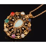 A multi gem-set oval pendant/brooch of pierced design: with central pear shaped opal within a