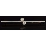 A diamond two stone bar brooch: stamped '15ct & PT' with circular old brilliant-cut diamonds