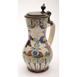 A German pewter mounted polychrome faience jug: of baluster form, the cover with ball thumb piece,