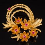 A ruby mounted floral spray brooch: set with six circular rubies, stamped '18k', 13gms gross weight.