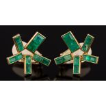 A pair of stylized emerald clip earrings: each with rectangular-cut emeralds and stamped '14K',