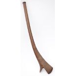 A Fijian war club of gun-stock type: the blade with incised geometric decoration, on a curved shaft,