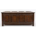 An early 18th Century oak rectangular coffer:, of moulded panel construction, with a hinged top,