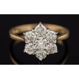 An 18ct gold and seven stone diamond, circular cluster ring: with round,