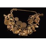 A 9ct gold circular-link bracelet: with twenty five various attached charms including a mounted