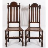 Two 17th Century oak dining chairs:, the backs with arched moulded top rails and turned finials,