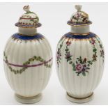 Two Worcester tea canisters and covers: both of reeded ovoid form with flower finials and gilded