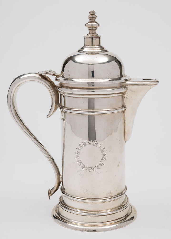 A George VI silver hot water jug, maker Walker & Hall, Sheffield, 1939: with sunburst crest,