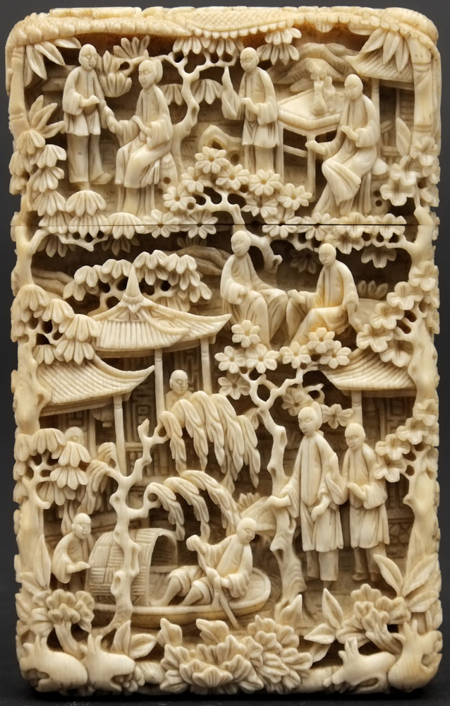 A Canton ivory card case: finely carved overall with figures, pagodas, dragons, flowers and foliage,