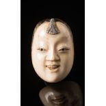 A Japanese carved ivory netsuke: Meiji period (1864-1912) of Mambi's mask (see Davey p.