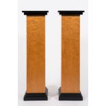 A pair of Art Deco burr maple veneered and ebonised square pedestals: raised on stepped plinth