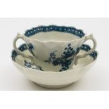 A Worcester blue and white chocolate cup and saucer: of double ogee form with scroll handles,