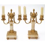 A pair of 19th century French ormolu and alabaster twin branch candelabra: with garland decorated