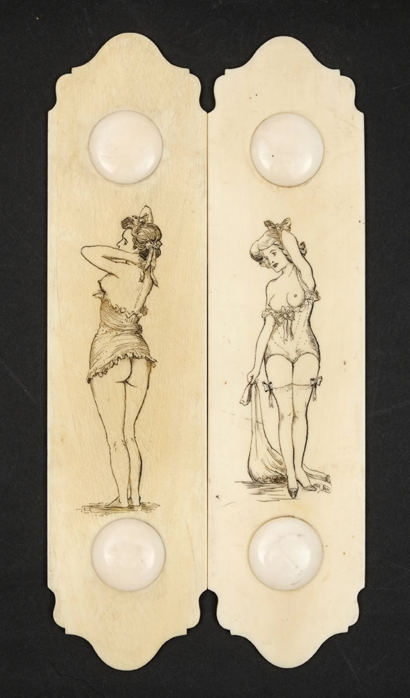 A pair of late 19th century French ivory and penwork door finger panels: of elongated cartouche