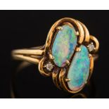 An opal two stone ring: the two irregular opals approximately 10mm and 11mm total length and