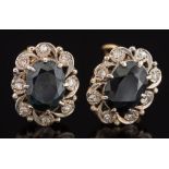 Pair of sapphire and diamond oval cluster earrings: each with an oval sapphire claw-set within a