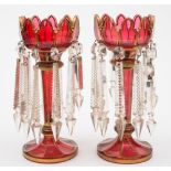 A pair of Bohemian ruby and gilt glass lustres: with petal shaped rims and fluted stems,